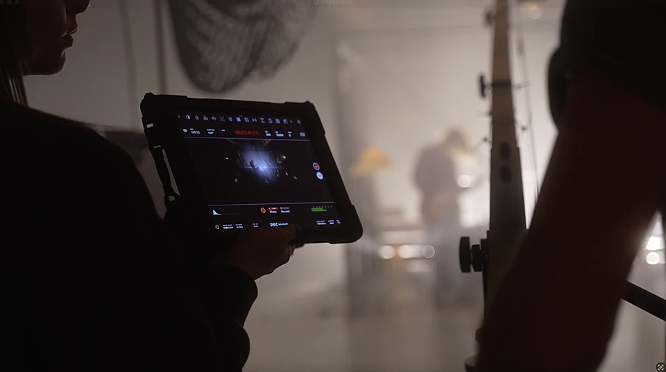 Monitoring a take on a field monitor during a video production shoot